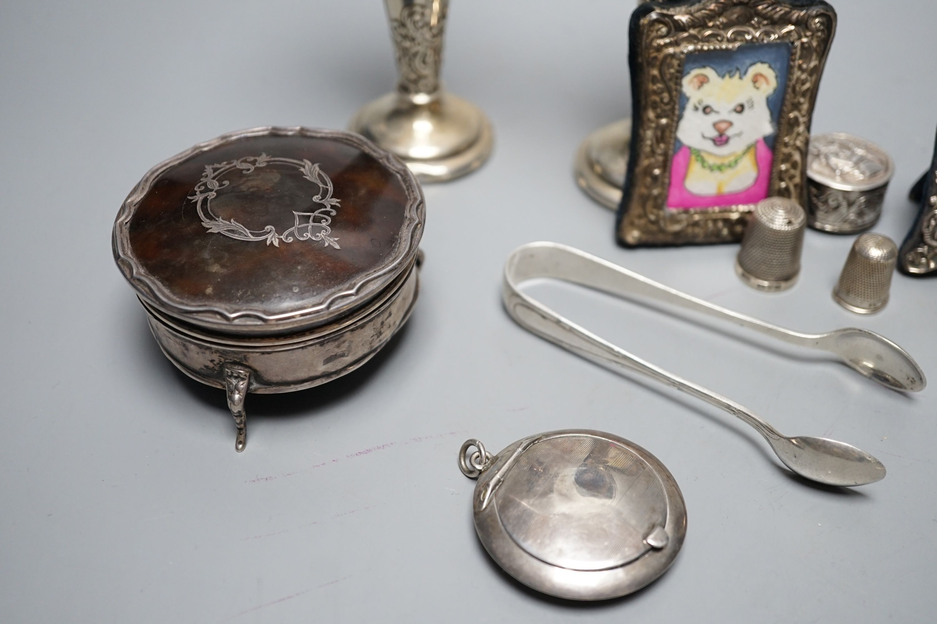 Mixed collectable silver including a pair of silver posy vases by William Comyns, 13.6cm, a George V silver and tortoiseshell trinket box, two small silver mounted photograph frames, four silver thimbles, compact, pill b